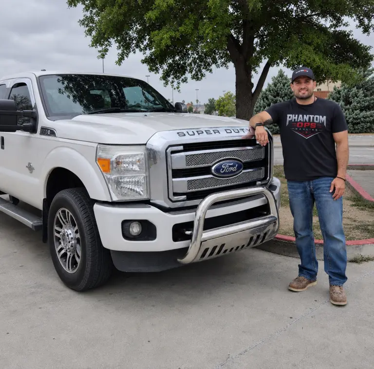 Phantom Ops owner John Salinas beside his work truck
